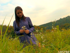 Teen beauty in a grass field of flowers